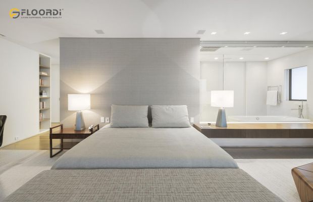 A full wall headboard extends behind floating nightstands to create a seamless and cohesive unit