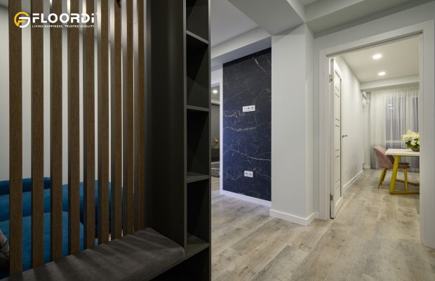 A modern entryway featuring a stylish vertical wood slat wall divider